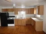 Electric range, refrigerator, beautiful oak cabinets and spacious counter, light and ceiling fan.