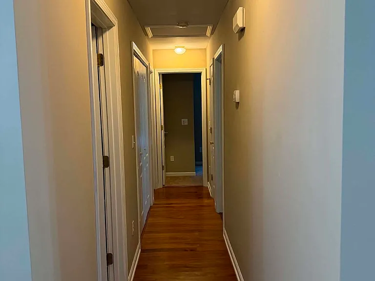 Hallway leads to guest bathroom, laundry room (washer and dryer included), and 3 bedrooms