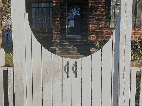 Welcoming front gate. Front door in the background. Window on the left is LR, and widow on the right is master bedroom.