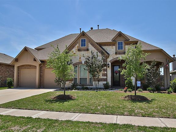 This stone and brick home has lovely curb appeal with decorative features like the wood corbels above and an all brick front por
