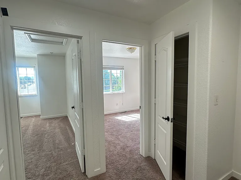 upstairs bedrooms with laundry on the left and linen closet to the right.