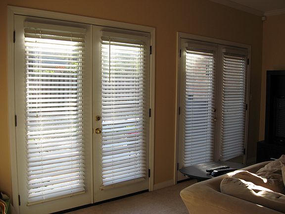 Wall of French doors in living opening to the deck