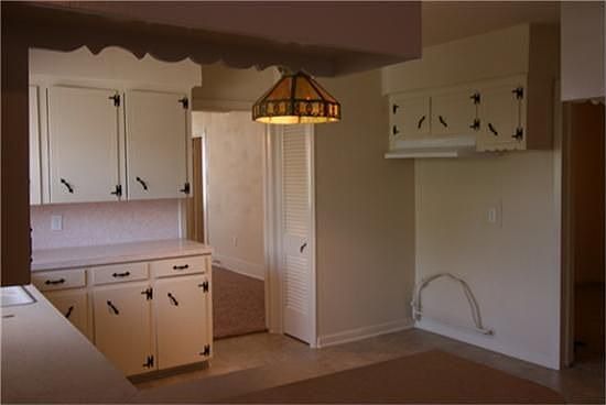  Freshly painted cabinets and new hardware in neutral tones.
