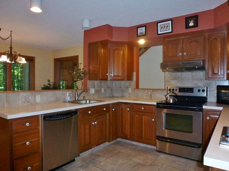 Cherry cabinets are featured in this beautiful and spacious kitchen that is open to the dining area and has views of the backyard!