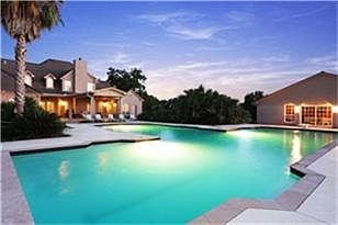 The pool house on the right has a kitchen area, separate dressing rooms with bathrooms and showers f