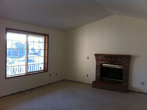 Living Room with Cathedral Ceiling and Brick Hearth Gas Fireplace