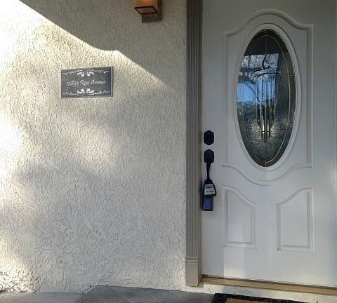 natural stone entry with customized street sign and light fixture
