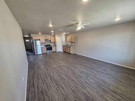 Living Area and View of Kitchen - Refrigerator and Stove