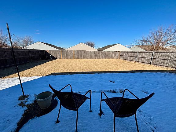 Large fenced backyard with 8x8 patio (covered in snow).
