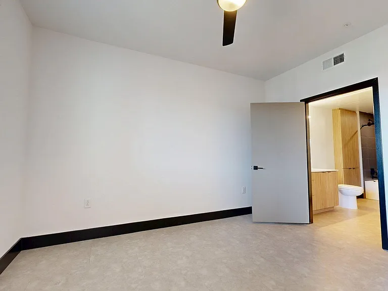 Spacious apartment Bedroom with Wood-Style Flooring.