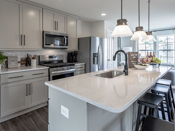 Island kitchen in a DRB Homes York II model at the Archer s Rock community.