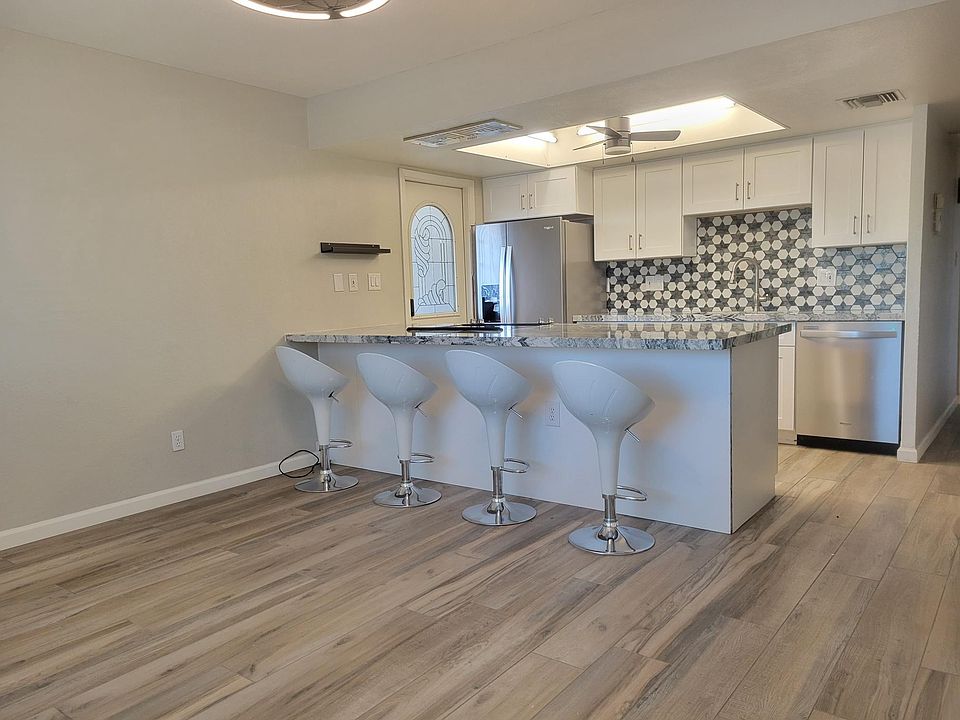 Fully remodeled kithen with new cabinetry, granite counters, stainless steel appliances and bar seating.