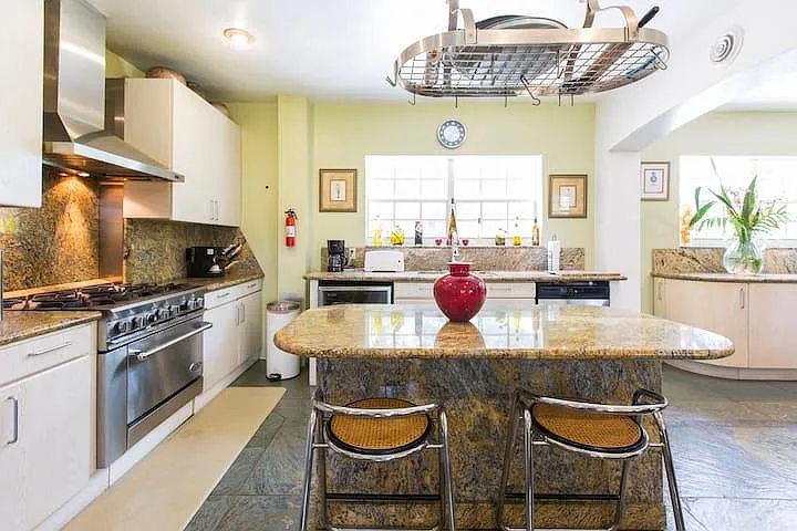 The kitchen is huge with a commercial gas range and an Island. All cooking utensils for a great chef.