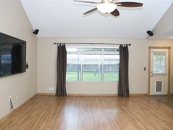 A large window overlooks the backyard.