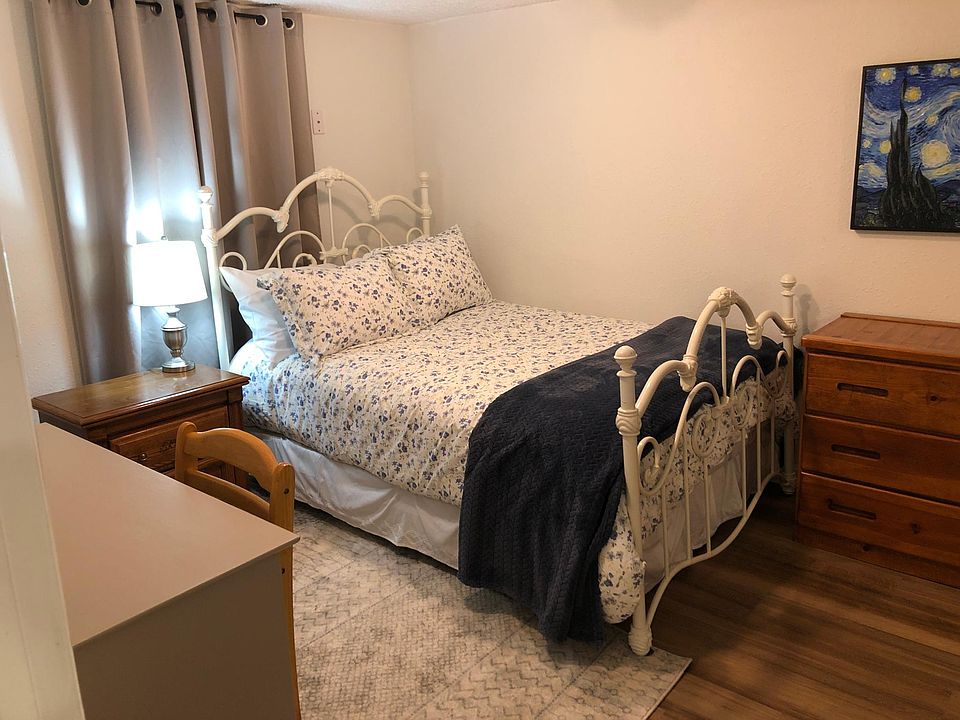 Quiet bedroom with blackout curtains and egress window