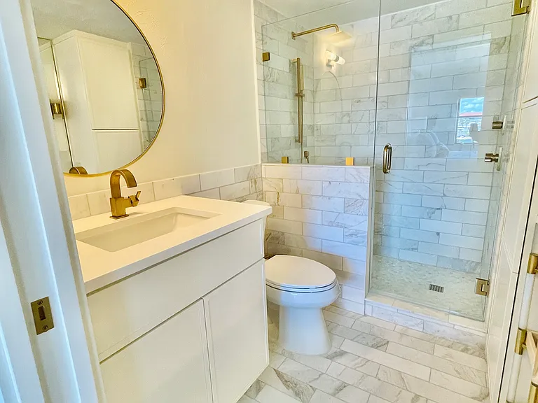 Primary bath with marble tiles and designer finishes