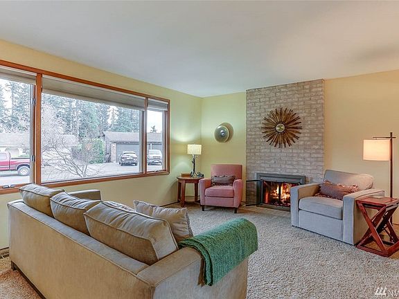 Cozy up next to the gas fireplace in the living room.The large picture window keeps this space light and bright in all seasons.  All windows, slider and french doors are by Anderson. 