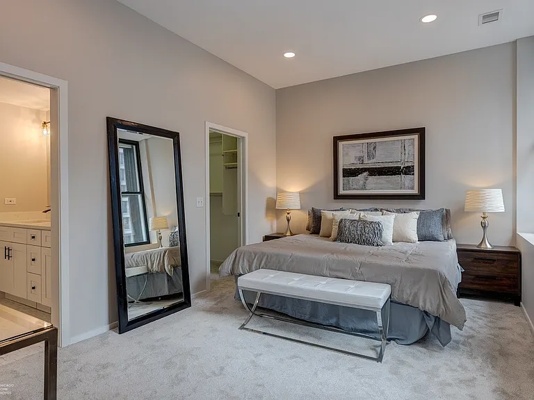 Master bed and door to bathroom / door to walk-in closet
