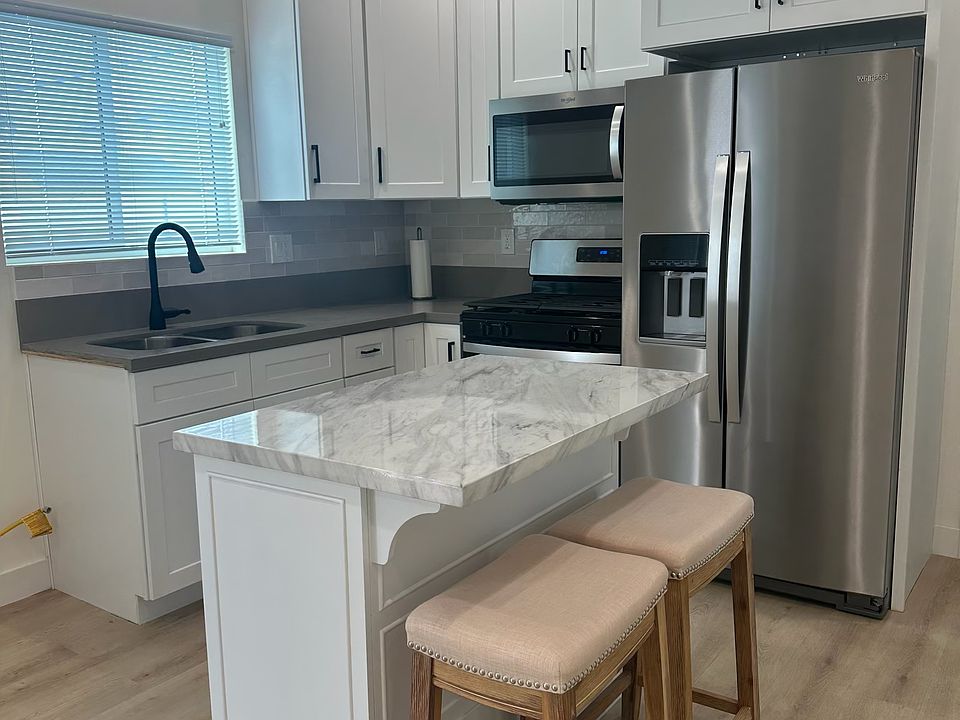 beautiful kitchen with quartz counters and walkin pantry