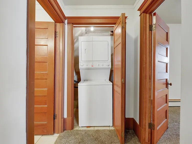 Off of the kitchen is the bathroom, laundry in unit, and primary bedroom.