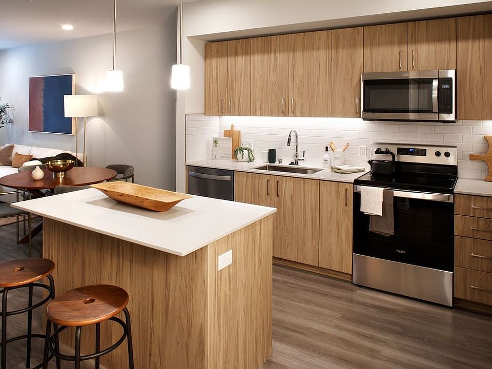 Design Collection II Kitchen with oak cabinetry, white quartz countertops, and white tile backsplash