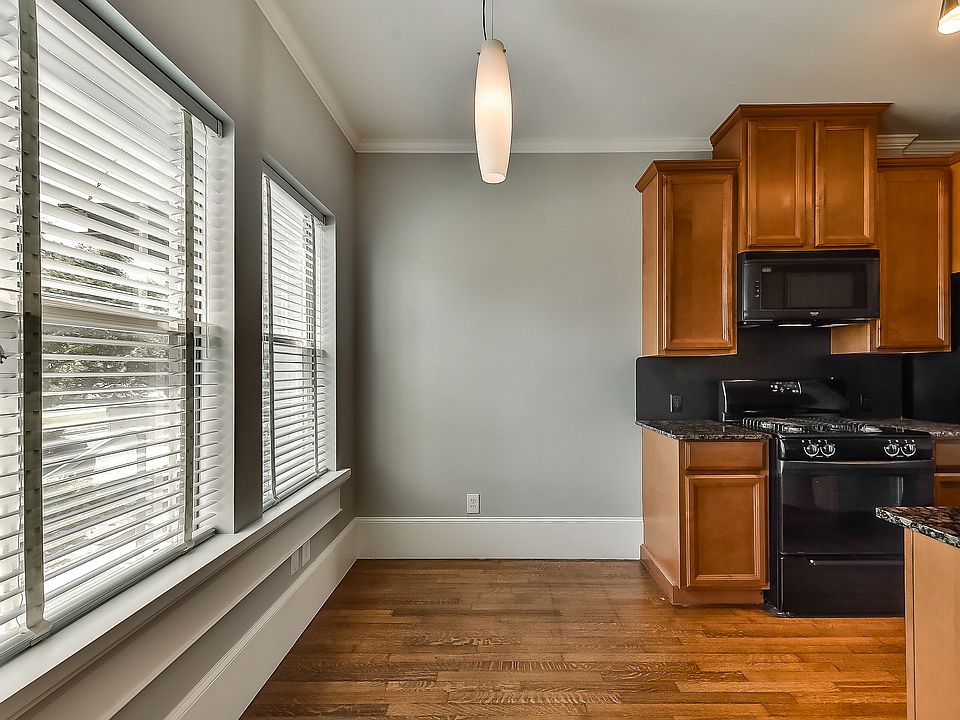 A wall of windows floods the dining room and kitchen with natural light. *Please note: image is representative and may not reflect the actual unit or condition of the unit listed.