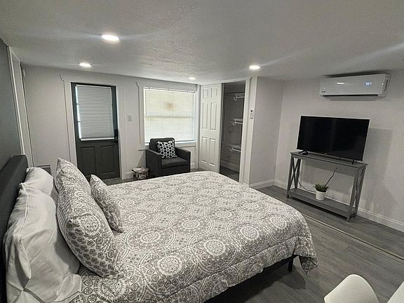 Room with A/C, premium linens, comfy pillows, and stylish artwork.