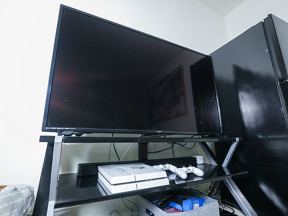 Angle view - TV with fridge and entertainment