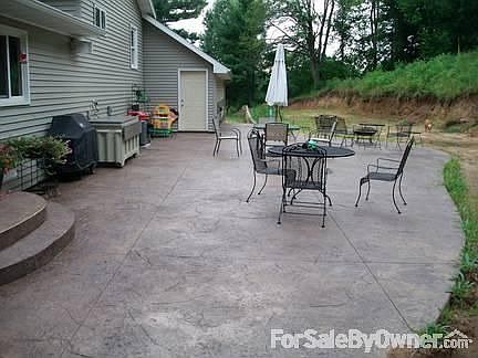 Exterior : Back yard with large stamped/colored concrete patio.