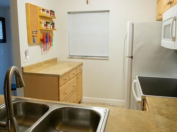 Kitchen includes a window blind that opens top to bottom or bottom to top.