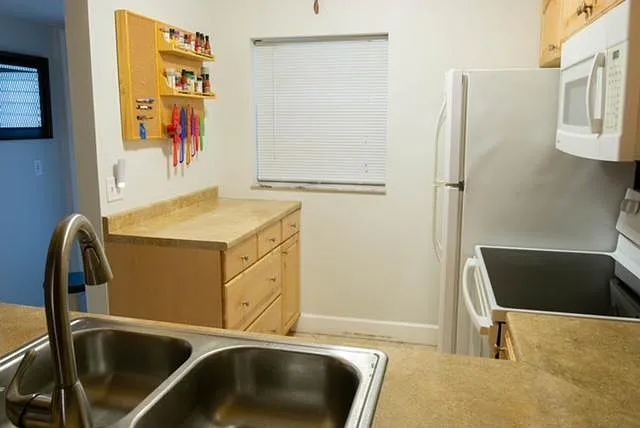 Kitchen includes a window blind that opens top to bottom or bottom to top. - 9420 Poinciana Pl