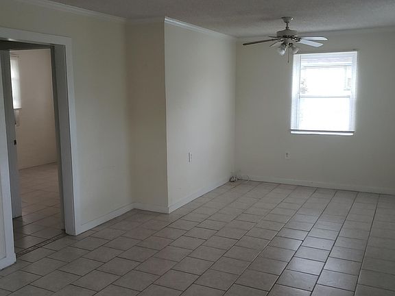 Looking from open living area to entrance to bedroom and bathroom
