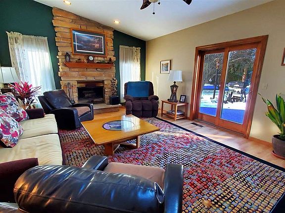 Great room has vaulted ceiling and patio door to a deck