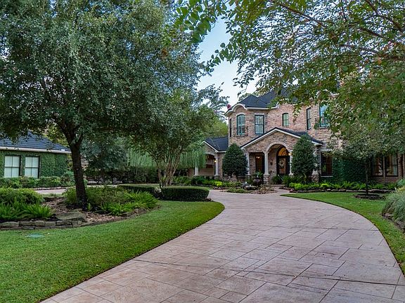Located on almost an acre and tucked away on a cul-de-sac street with a circular drive. Two garages for 4 cars plus a porte-cochere.