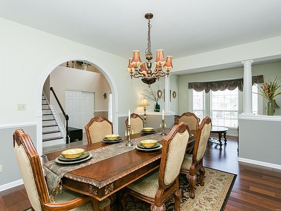 Hardwood floor, custom molding, opens to a living room with bay window