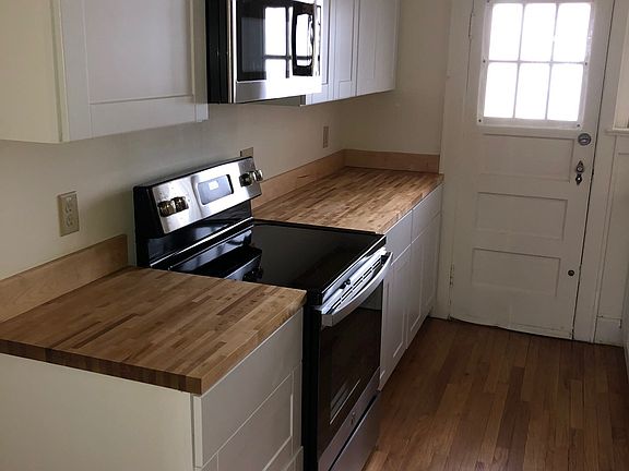 Kitchen with electric stove, microwave, and dishwasher