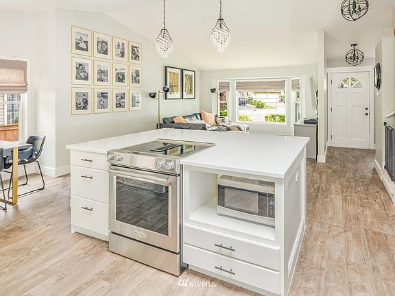 Stainless range & newer frige, updated lighting. Entry to the right, dining to the left & family room straight off the kitchen - excellent open concept Great Room.