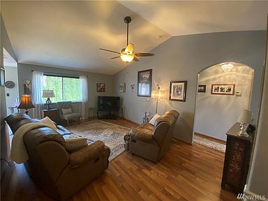 Vaulted ceilings in living room and beautiful laminate flooring.