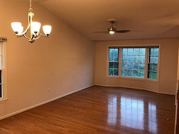 Living / dining room with updated fixtures and hardwood floors. Excellent entertaining space with gorgeous views framed by bay windows.
