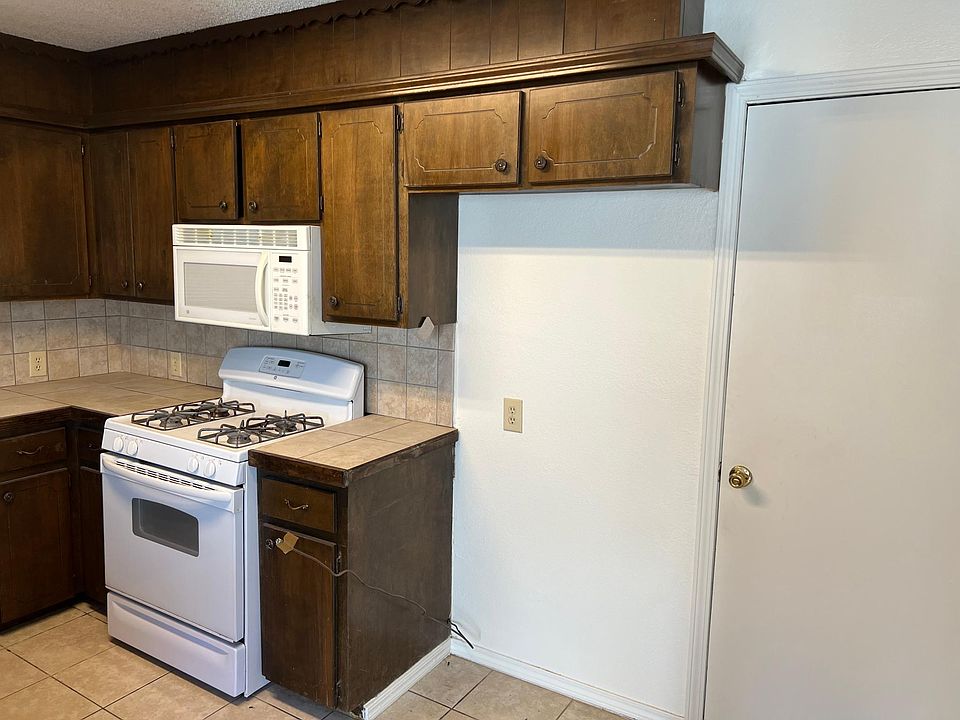 South side of kitchen, refrigerator space on right.
