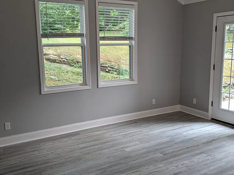 Master bedroom with double doors opening onto back patio