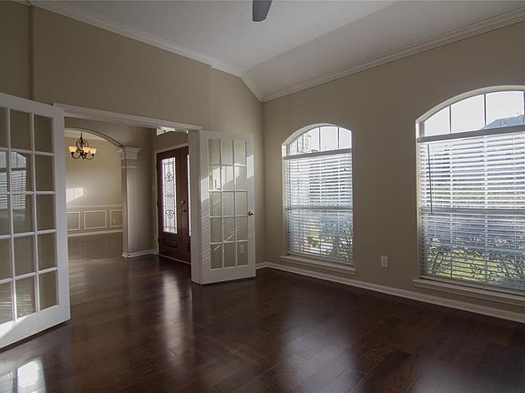 The study with French doors offers privacy for getting work done.