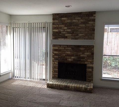 Large living room with fireplace and garden views.