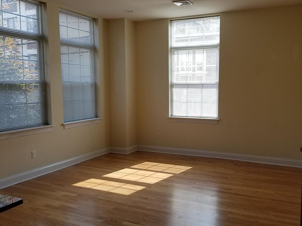 Wood Floors, Bright windows, high ceilings, recessed lighting and space for bar stools at the granite counter