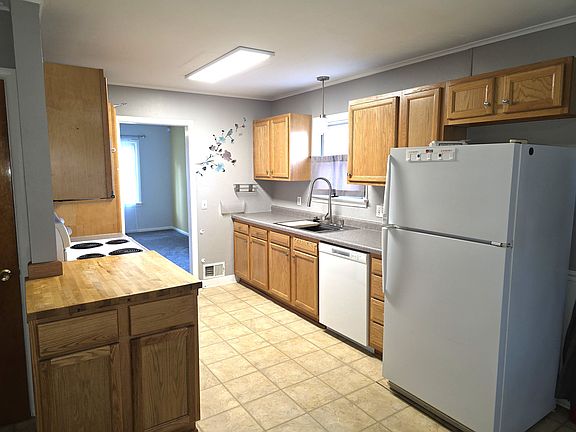 Kitchen has stove, refrigerator, microwave, and dishwasher