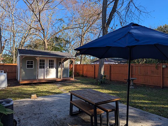 Back yard with large patio, picnic table and garden shed