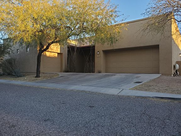 Front entry with vegetation. 2-car and 1-car garages.