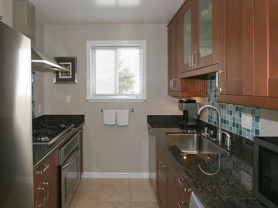 Remodeled Kitchen with Travertine Floors, Granite, Glass Tile Backsplash