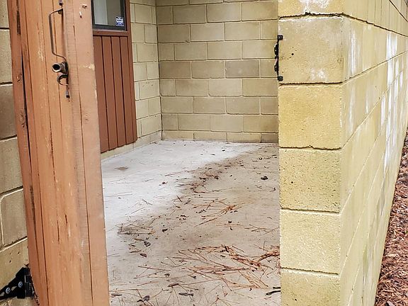 There is a gated porch in the front. Fine for your table and chairs. 
There is also an un-airconditioned storage closet for things like a bike.