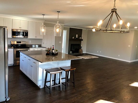 The heart of the home is the great room. This very large open space features the kitchen, dining area living room and entry space from the front door